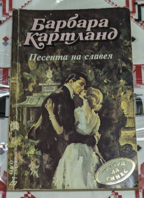 Корица на романа „Песента на славея“ от Барбара Картланд, изобразяваща романтична сцена с аристократични герои от 19-ти век.